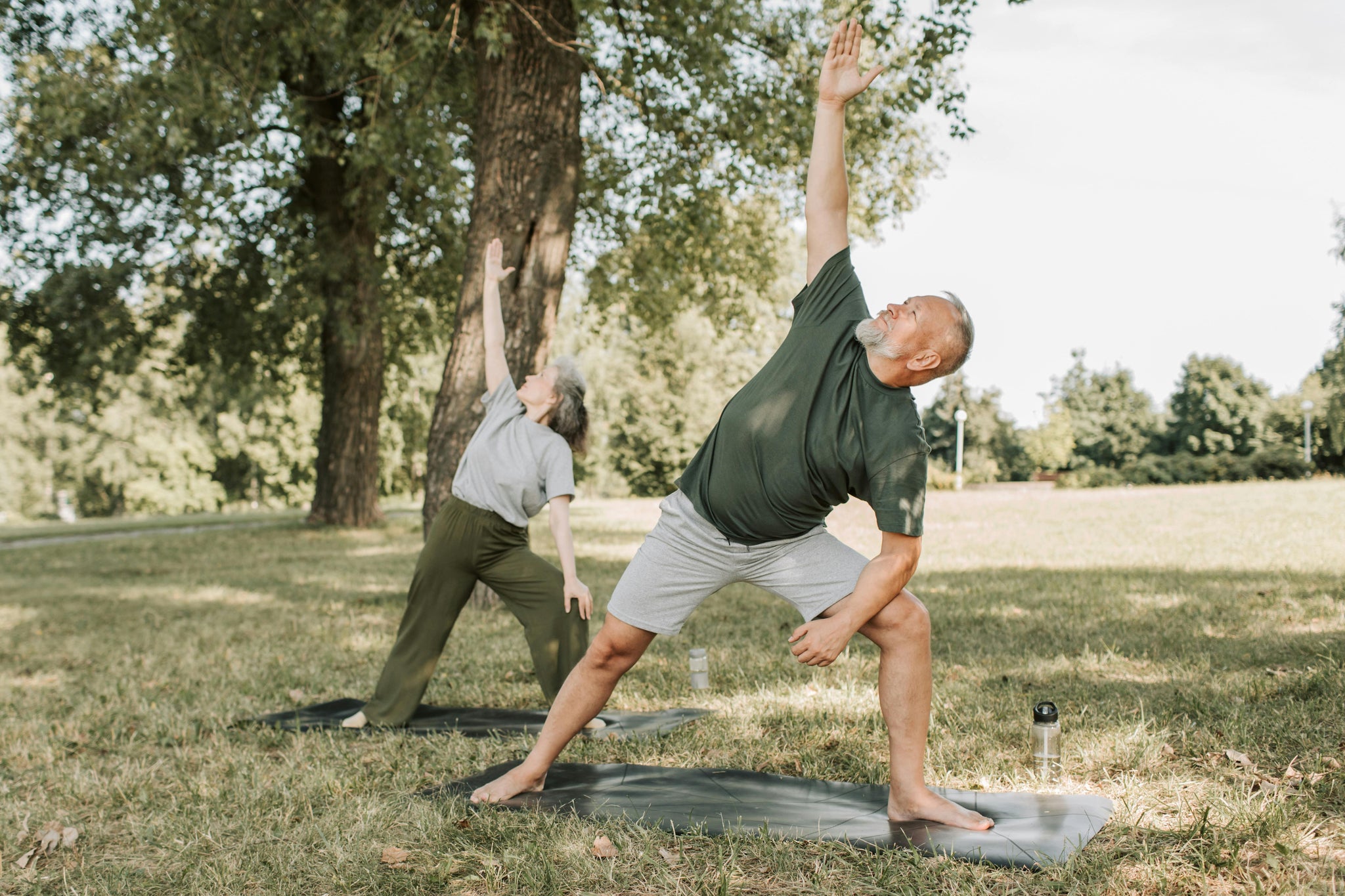 Man stretching with wife in park